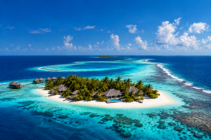 Aerial view of a low-lying island and coral reef in the Maldives